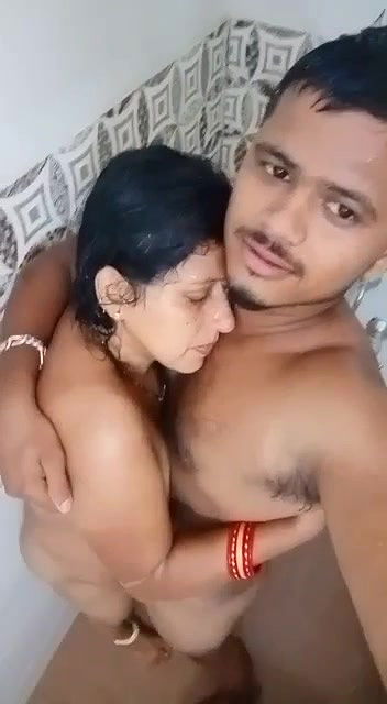 Young boy having nude shower with  teacher