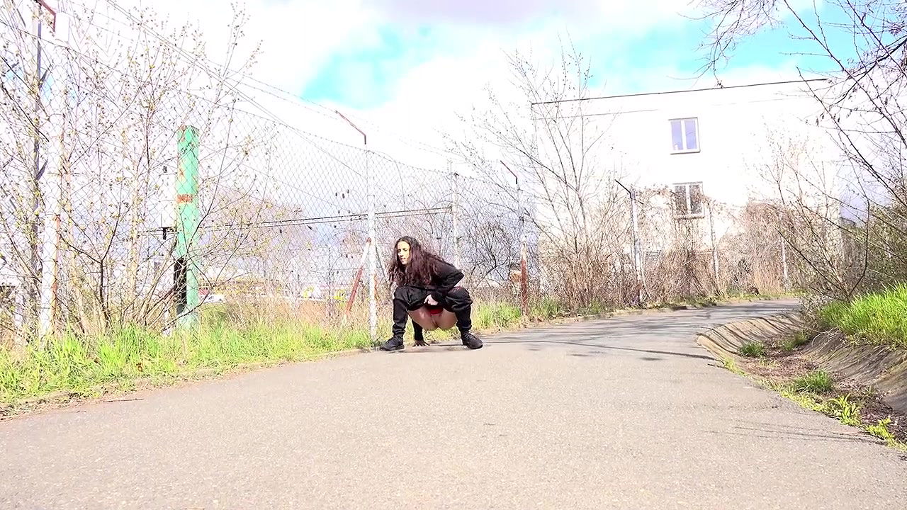 Ali B squats to pee next to the tramline