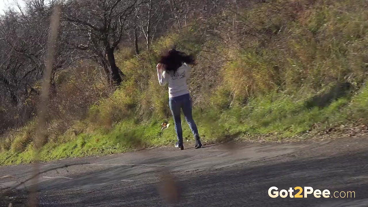Ali Bordeaux pees on a road in the suburbs