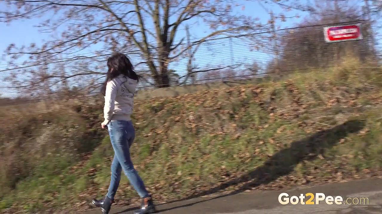 Ali Bordeaux pees on a road in the suburbs