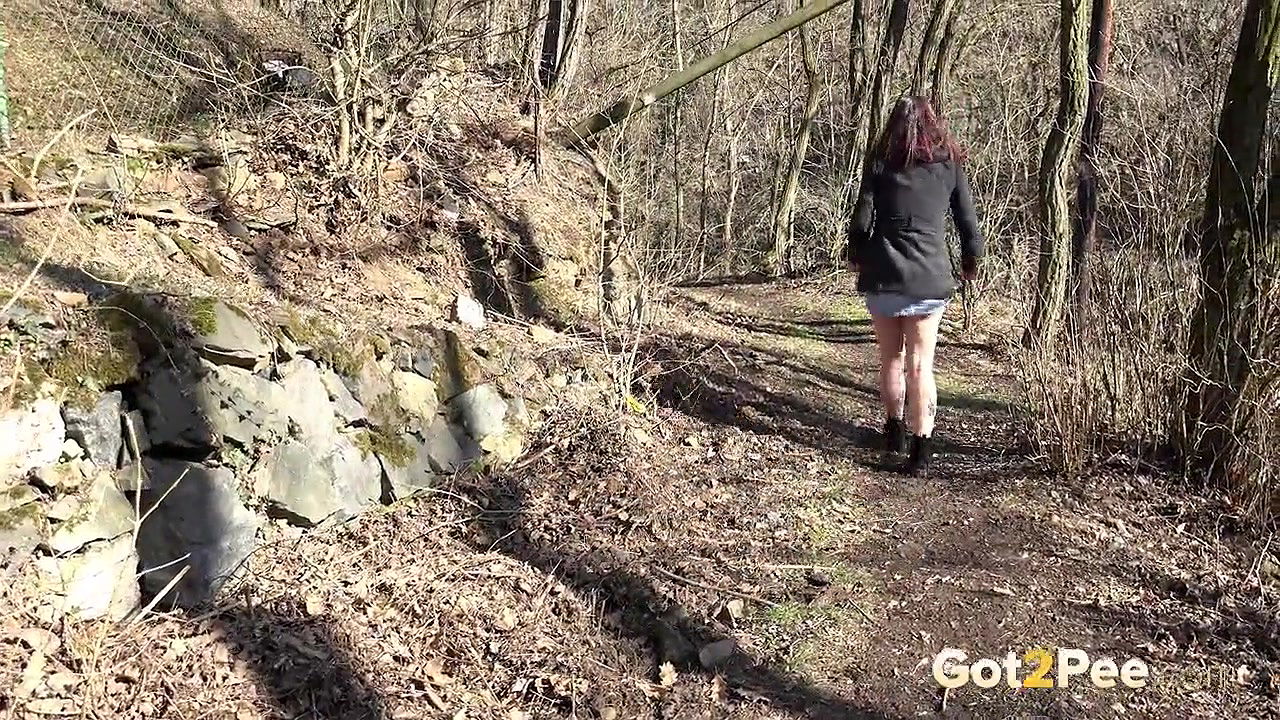 Amanda Hill squats to piss in the woodland