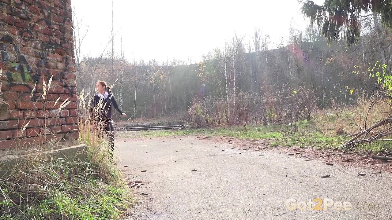 Antonia Sainz holds her pussy and pees outside