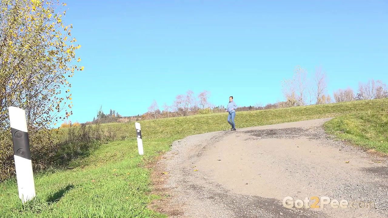 Antonia Sainz holds her pussy and pees outside