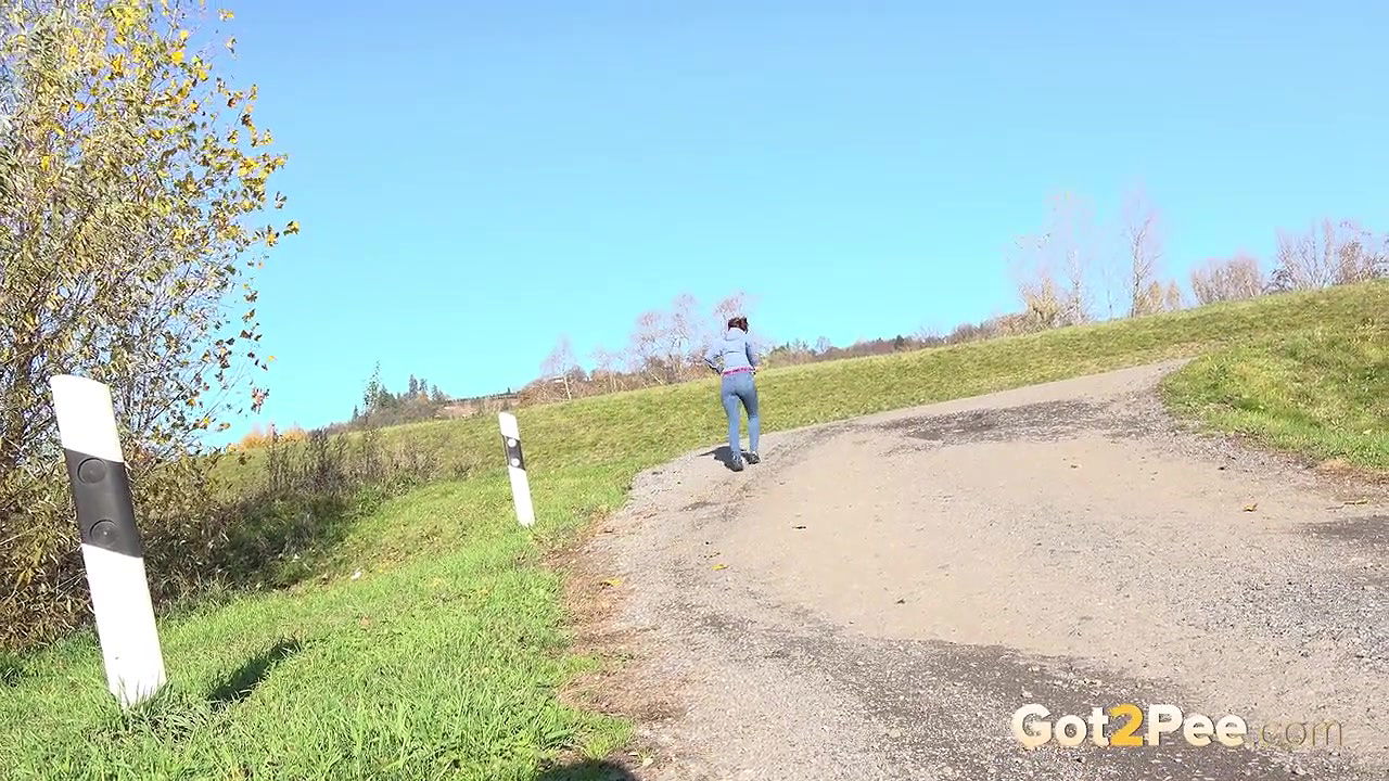 Antonia Sainz holds her pussy and pees outside