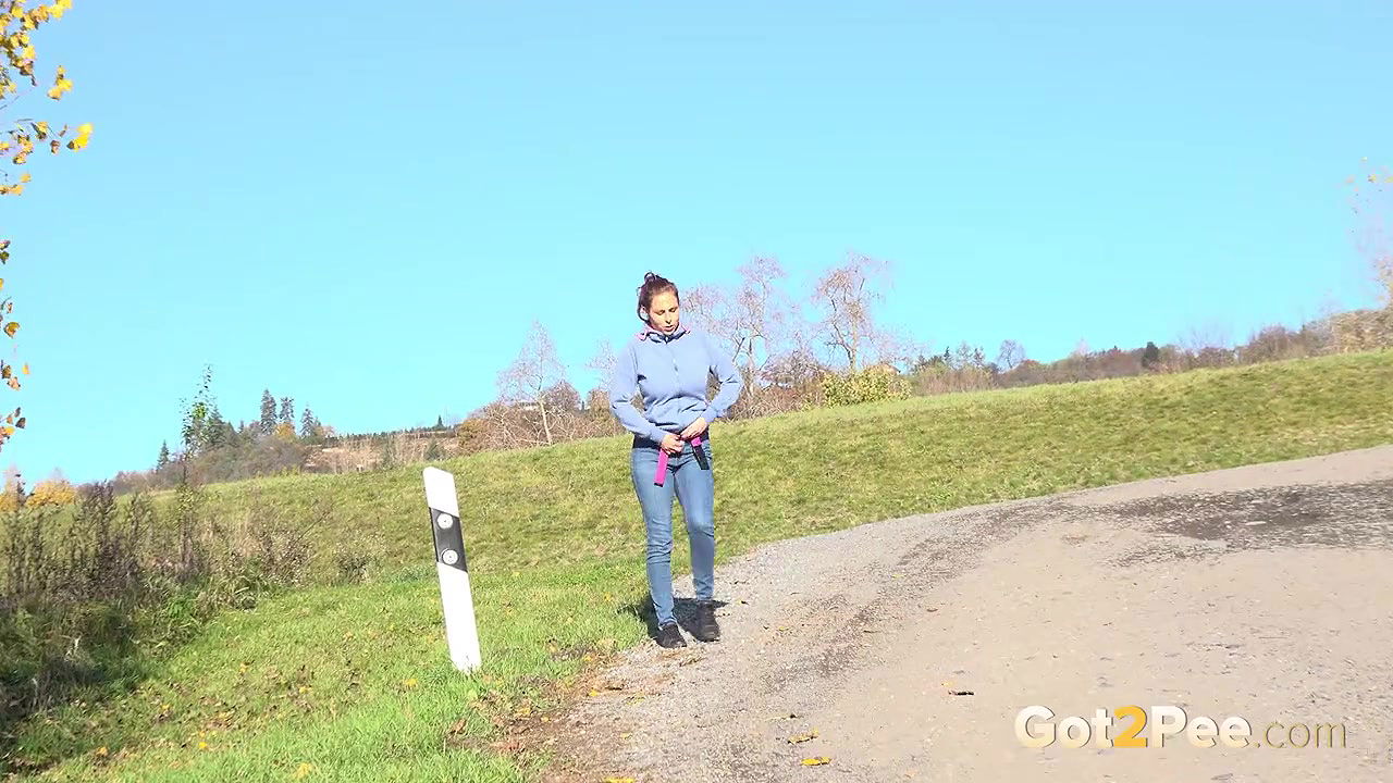 Antonia Sainz holds her pussy and pees outside