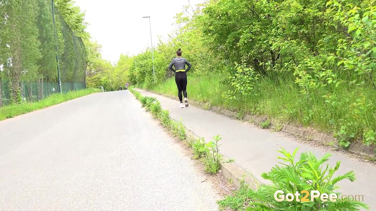 Barbe pees on the pavement outside in public