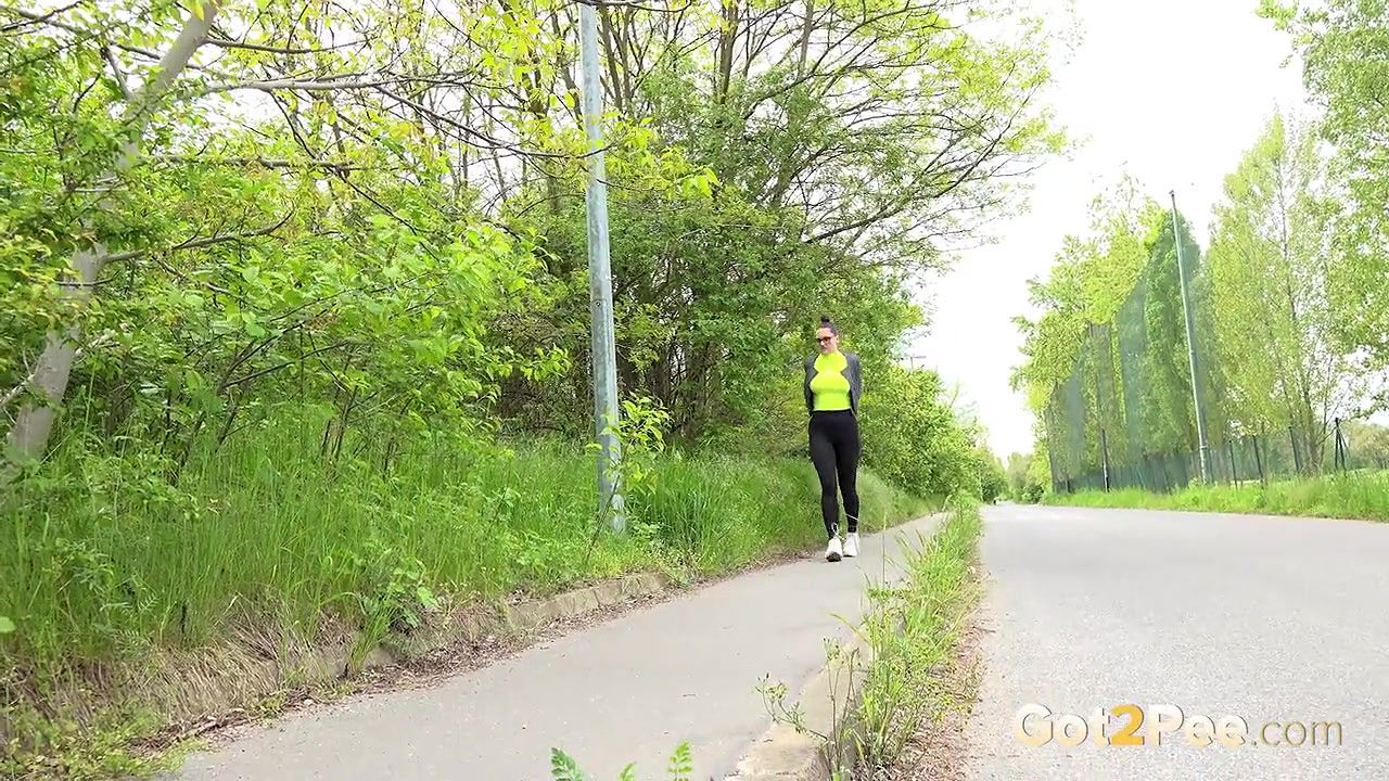 Barbe pees on the pavement outside in public