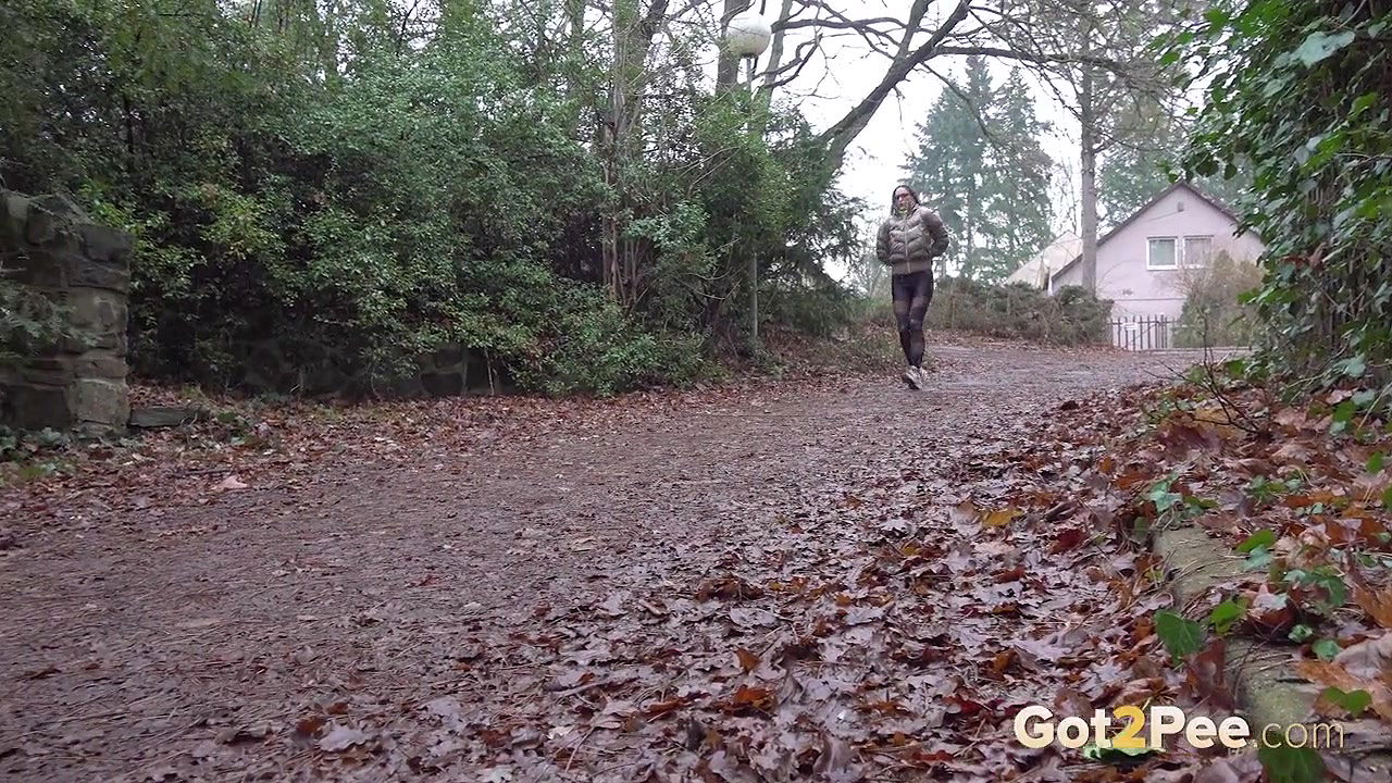 Barbe squats and pees on the ground in the rain