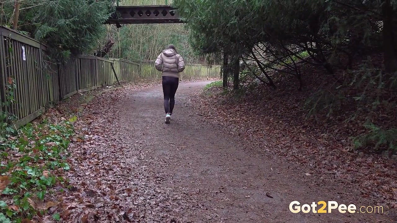 Barbe squats and pees on the ground in the rain