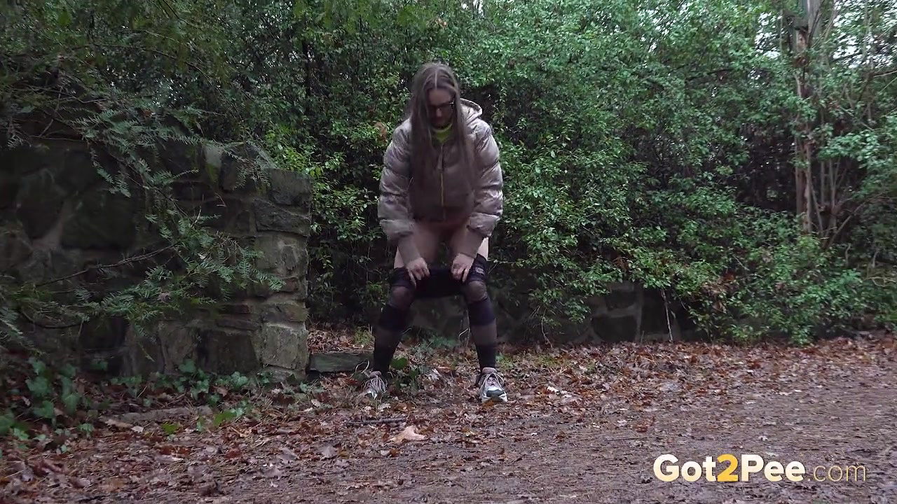 Barbe squats and pees on the ground in the rain