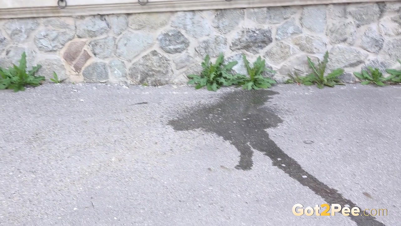 Blonde babe pisses outside in the city