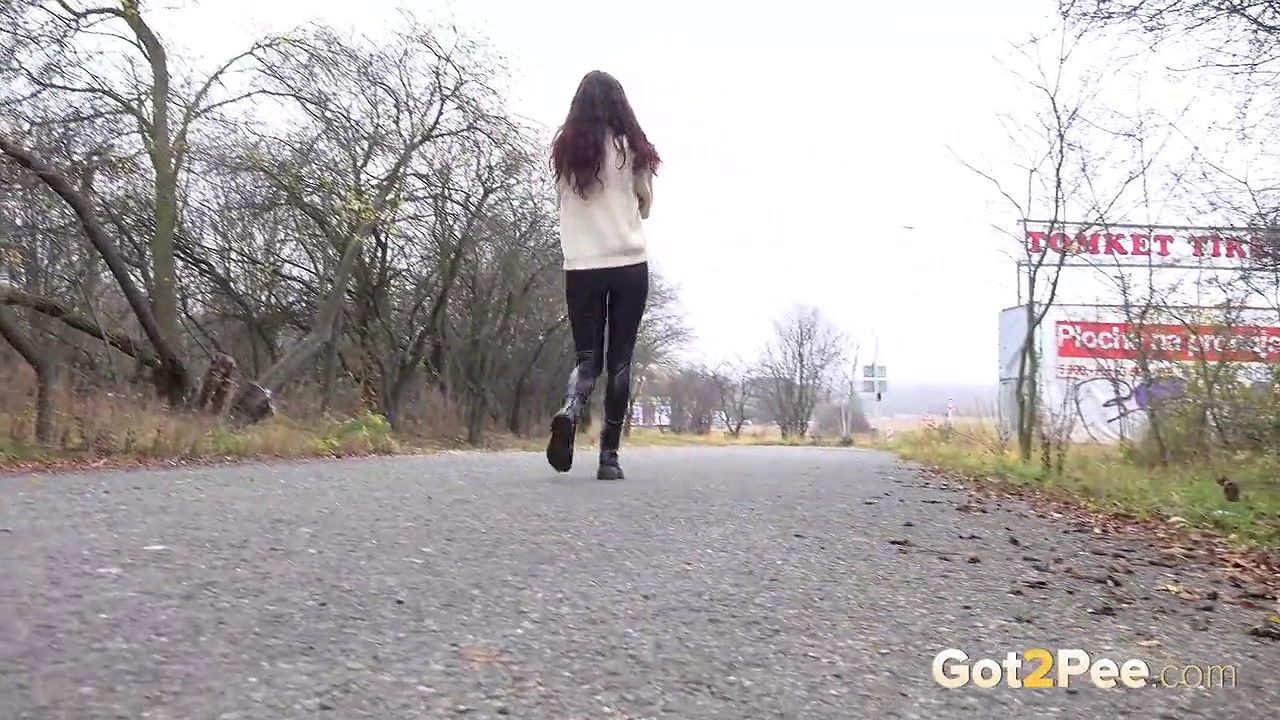 Ali B squats and pees over the ground outside