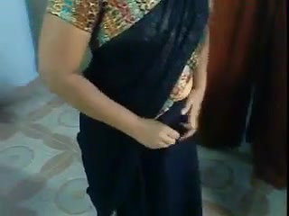 Indian aunty showing how to put on a sari