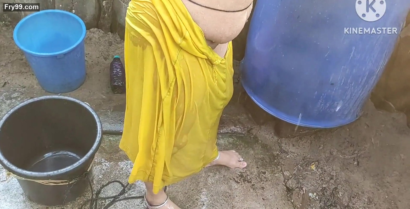 Indian house wife bathing outside