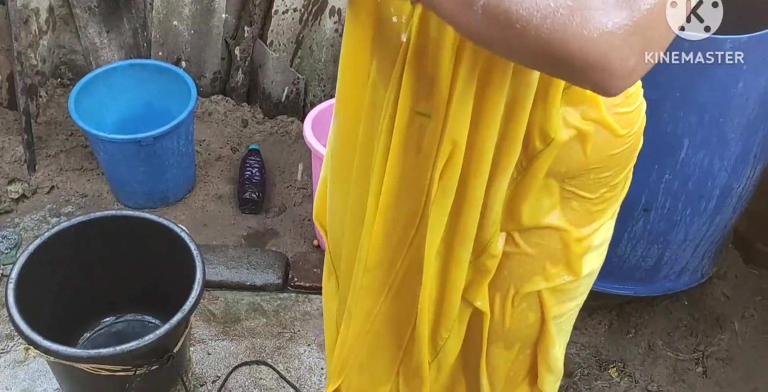 Indian house wife bathing outside