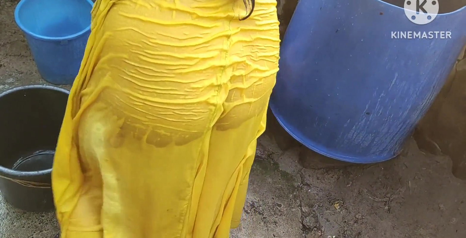 Indian house wife bathing outside