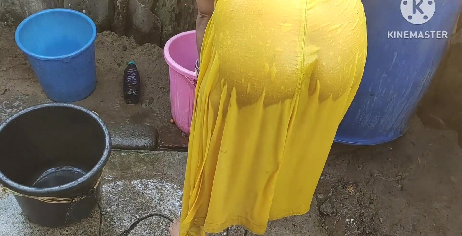Indian house wife bathing outside
