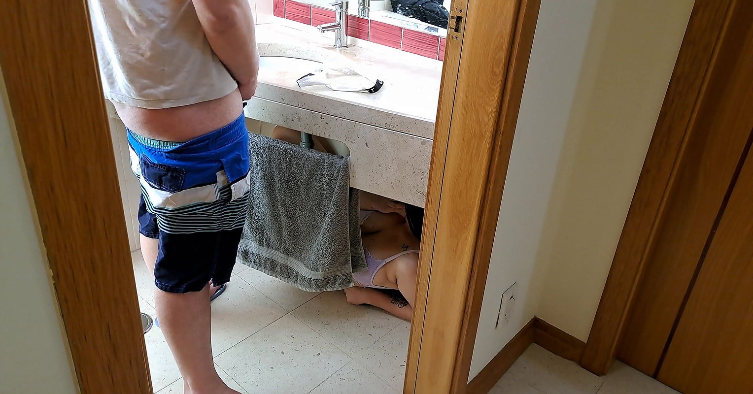 Stepsister receives facial cumshot through a hole in the sink