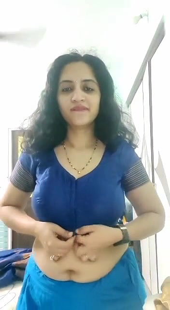 busty MILF removing blouse and showing big boobs