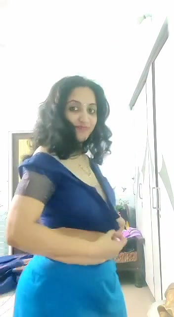 busty MILF removing blouse and showing big boobs