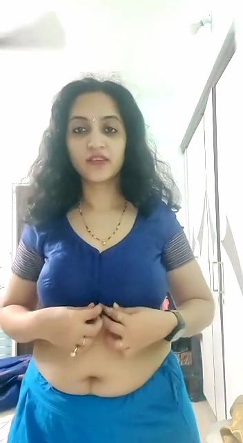 busty MILF removing blouse and showing big boobs