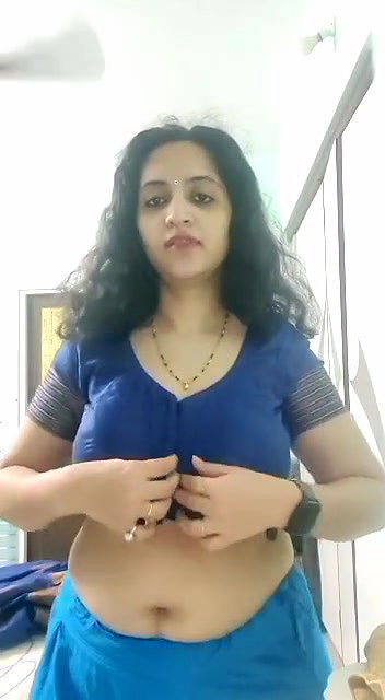 busty MILF removing blouse and showing big boobs
