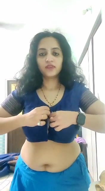 busty MILF removing blouse and showing big boobs