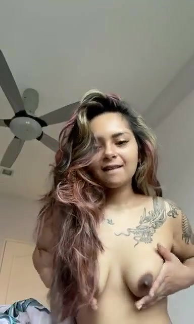 beautiful tattoed girl showing her boobies