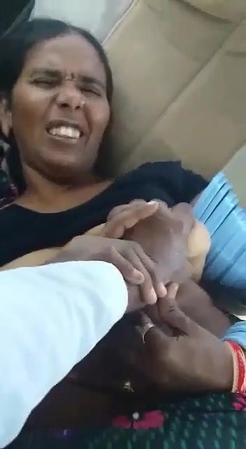 playing with mature boobs inside car