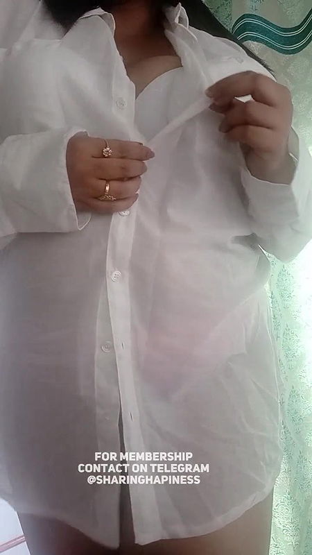 Naasha unbuttons shirt