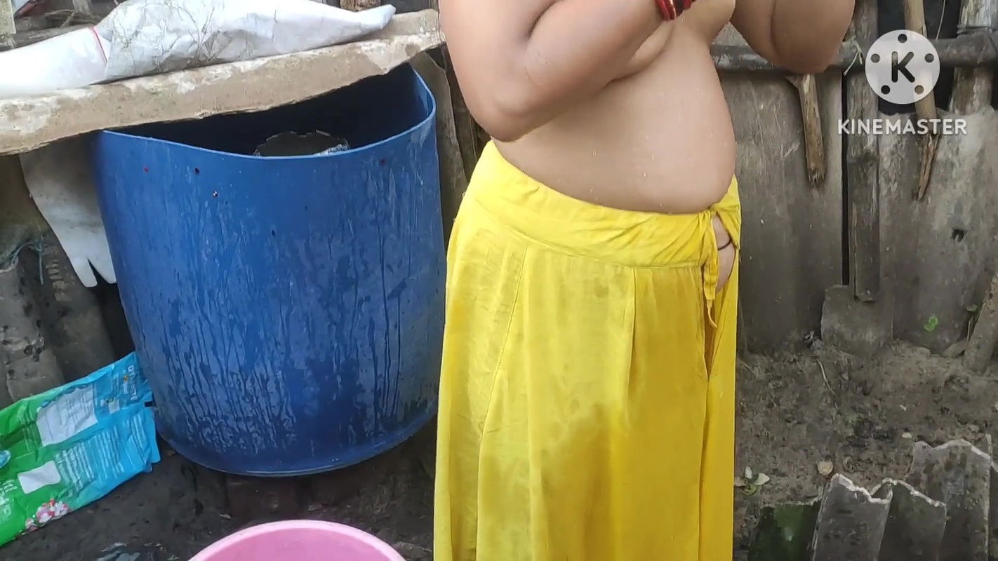 Indian woman bathing outside