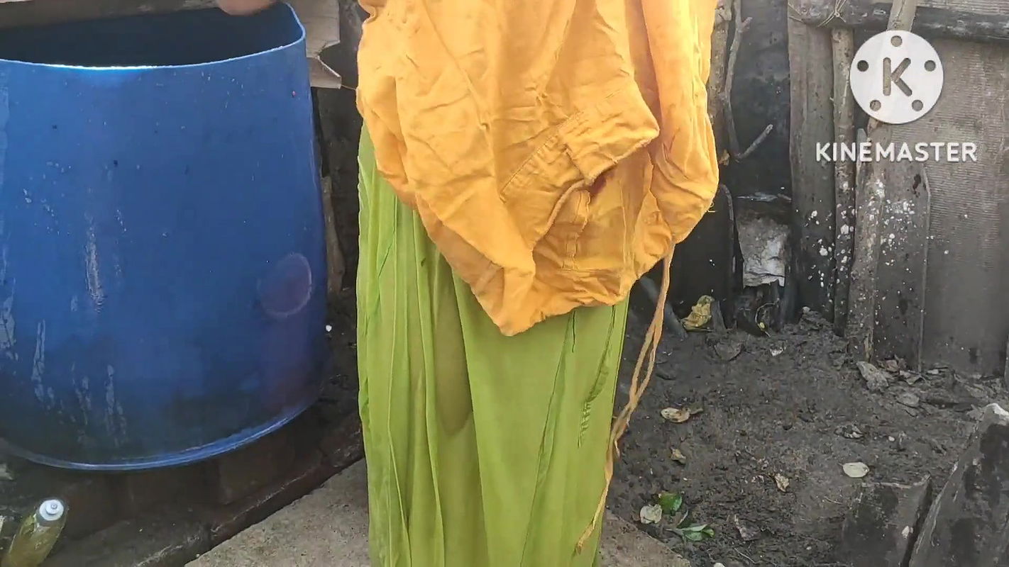 Indian housewife bathing outside with dance