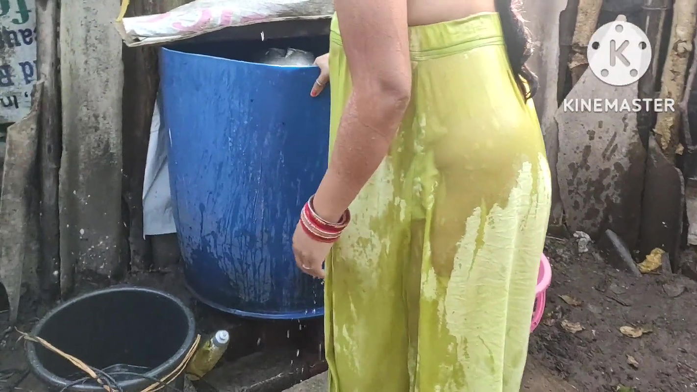 Indian housewife bathing outside with dance
