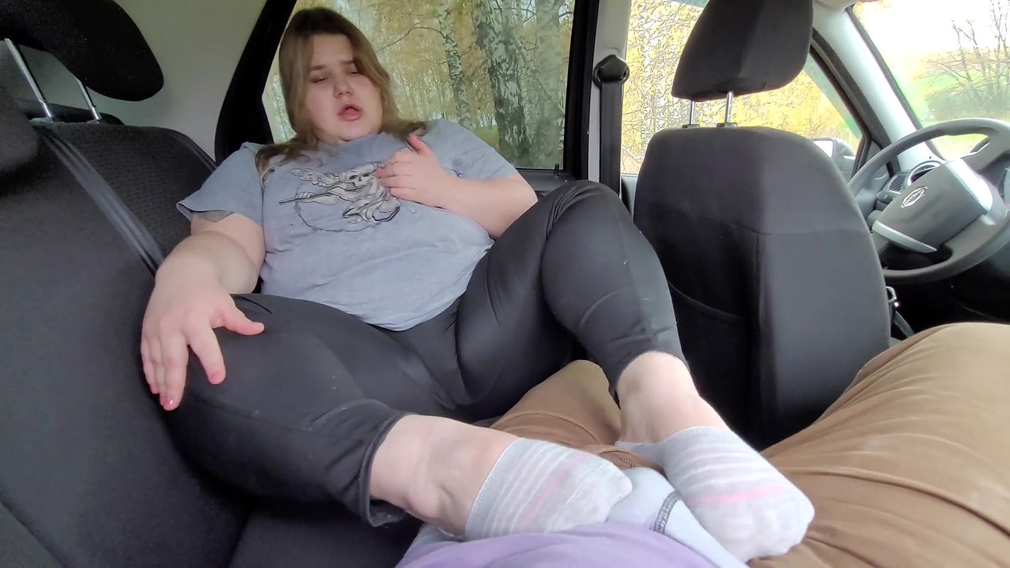 Footjob in the car with a big-ass stepmom