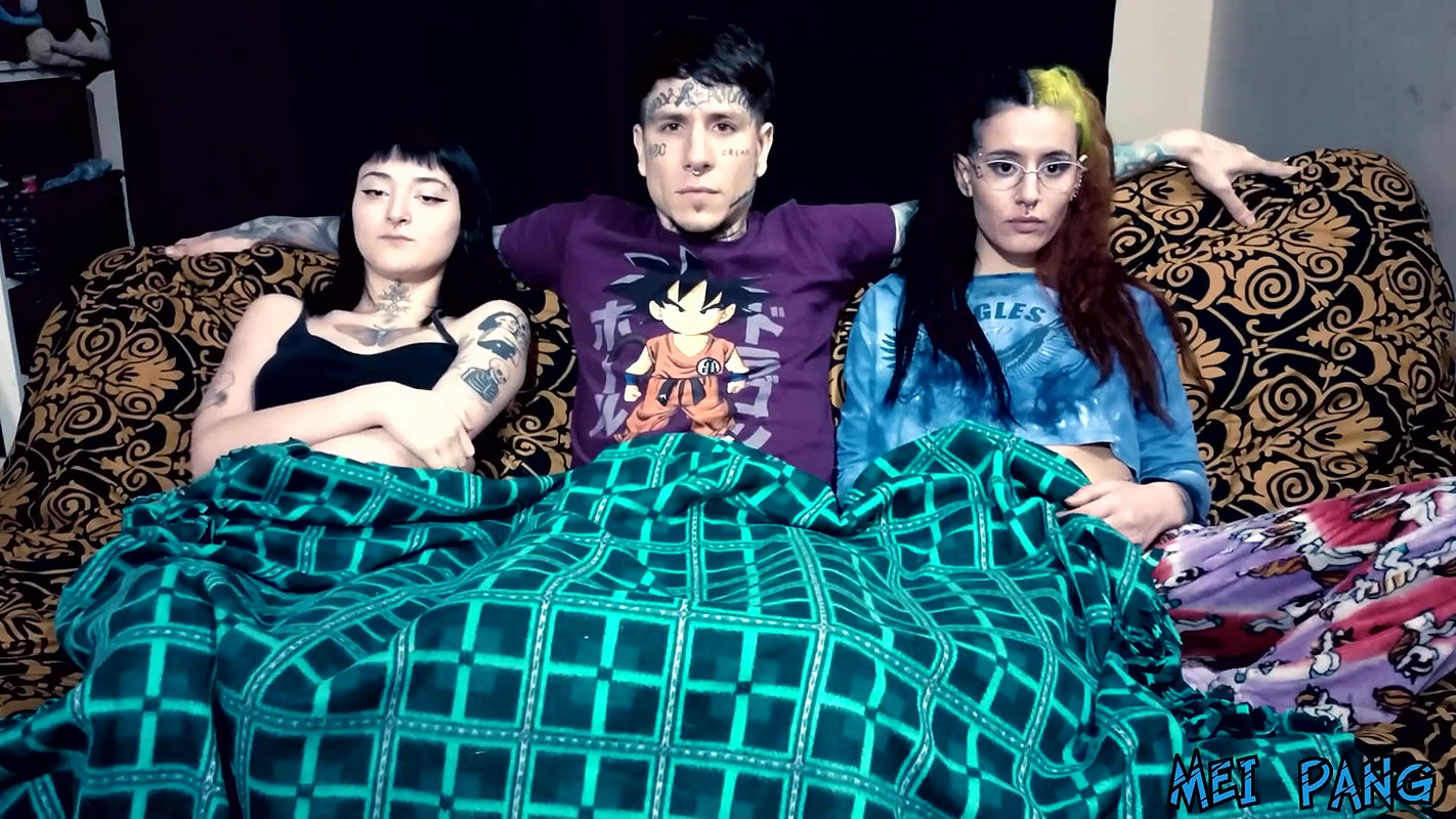 Punk dude with lots of tattoos is having a threesome with two skinny teens