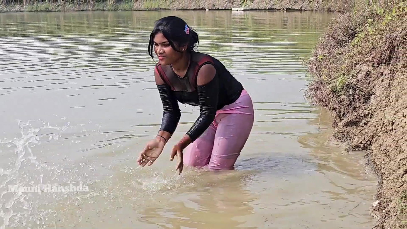 Bengali girl net fishing in Village pond