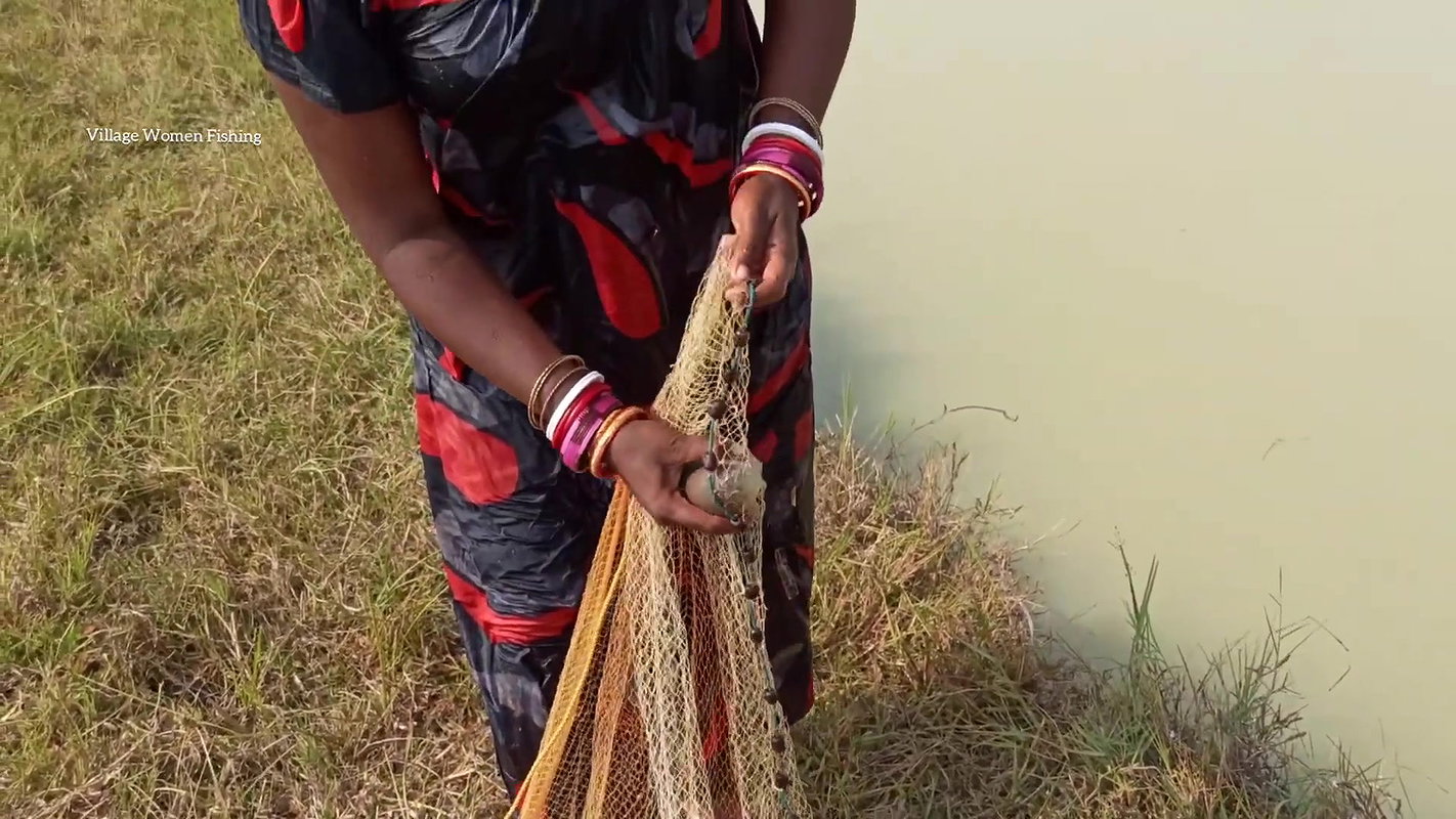 Amazing Lady fishing in village with bare hand and