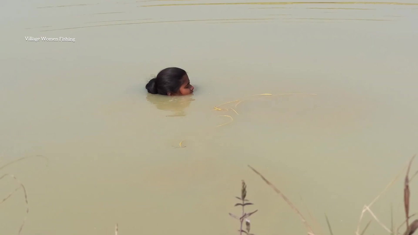 Amazing Lady fishing in village with bare hand and