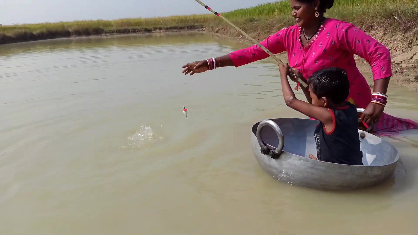 Mama Helping Her Little  Son to catch His first Fi