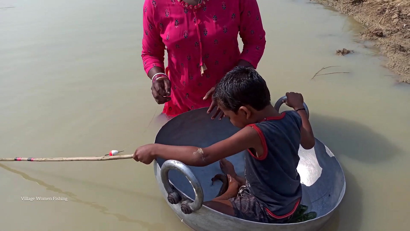 Mama Helping Her Little  Son to catch His first Fi