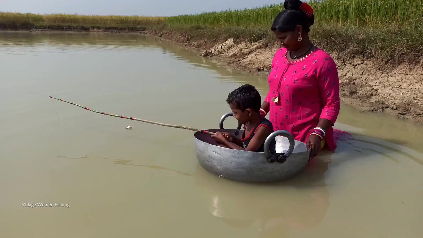 Mama Helping Her Little  Son to catch His first Fi