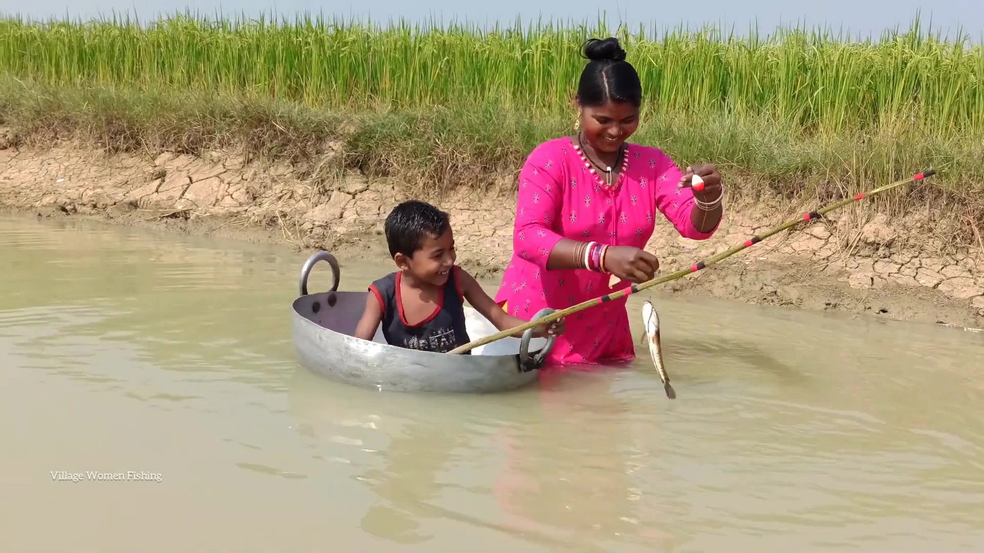Mama Helping Her Little  Son to catch His first Fi
