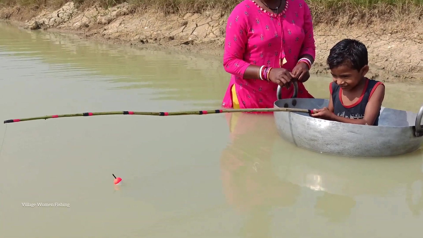 Mama Helping Her Little  Son to catch His first Fi