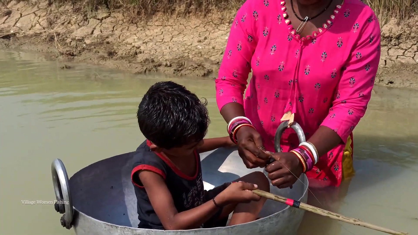 Mama Helping Her Little  Son to catch His first Fi