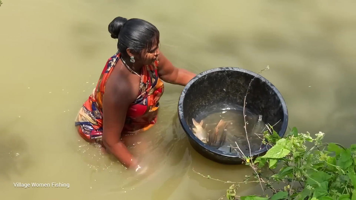 Traditional village women bare hand fishing   Amaz