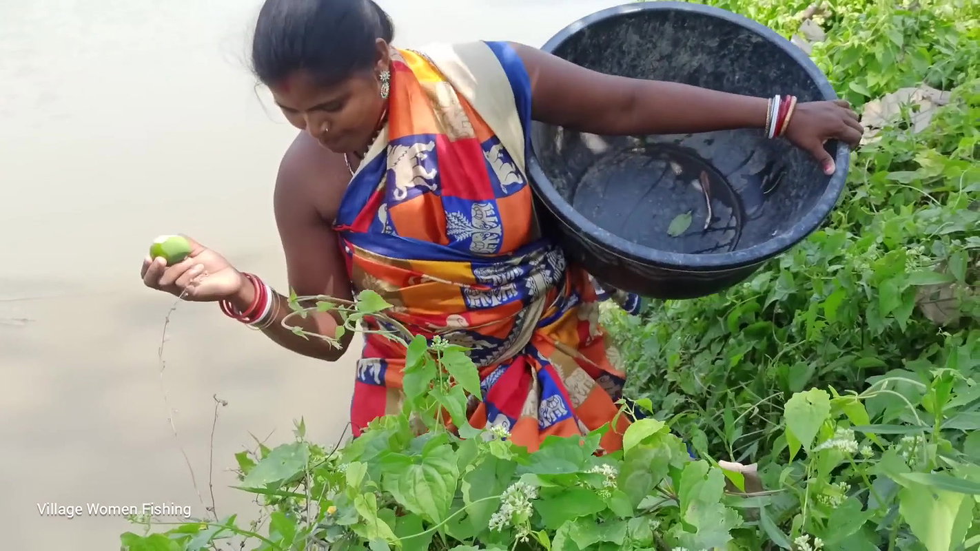 Traditional village women bare hand fishing   Amaz