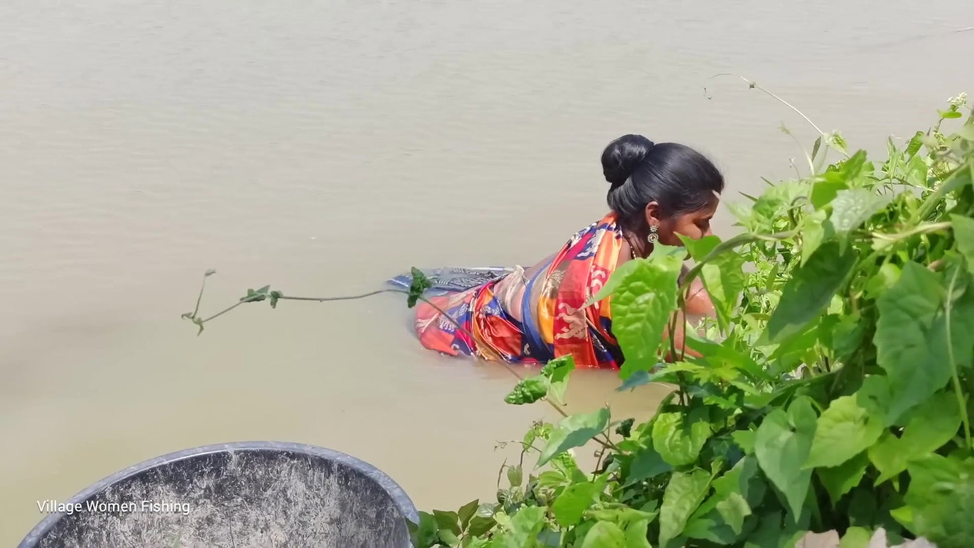 Traditional village women bare hand fishing   Amaz