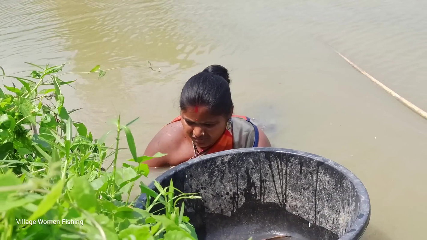 Traditional village women bare hand fishing   Amaz