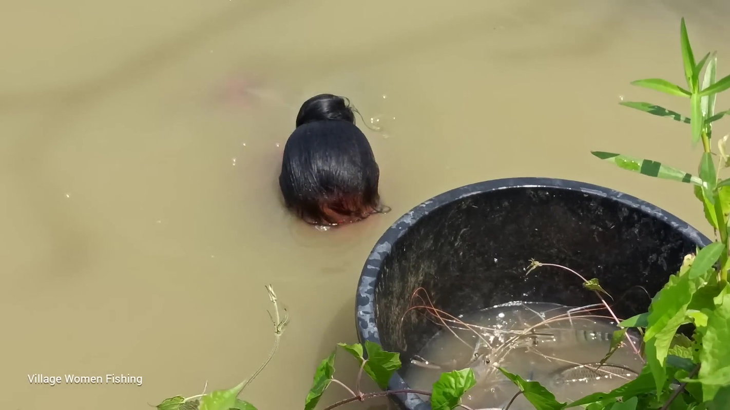 Traditional village women bare hand fishing   Amaz