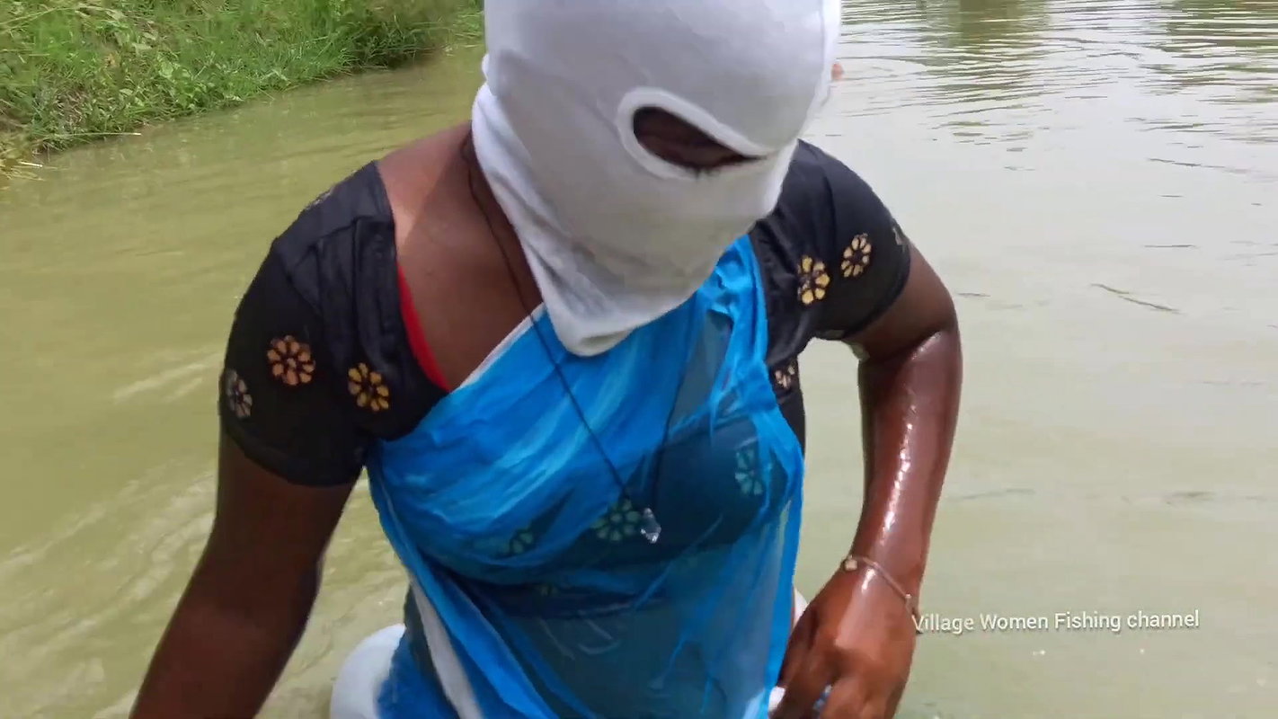 Village Masked Women Fishing in Dangerous Water